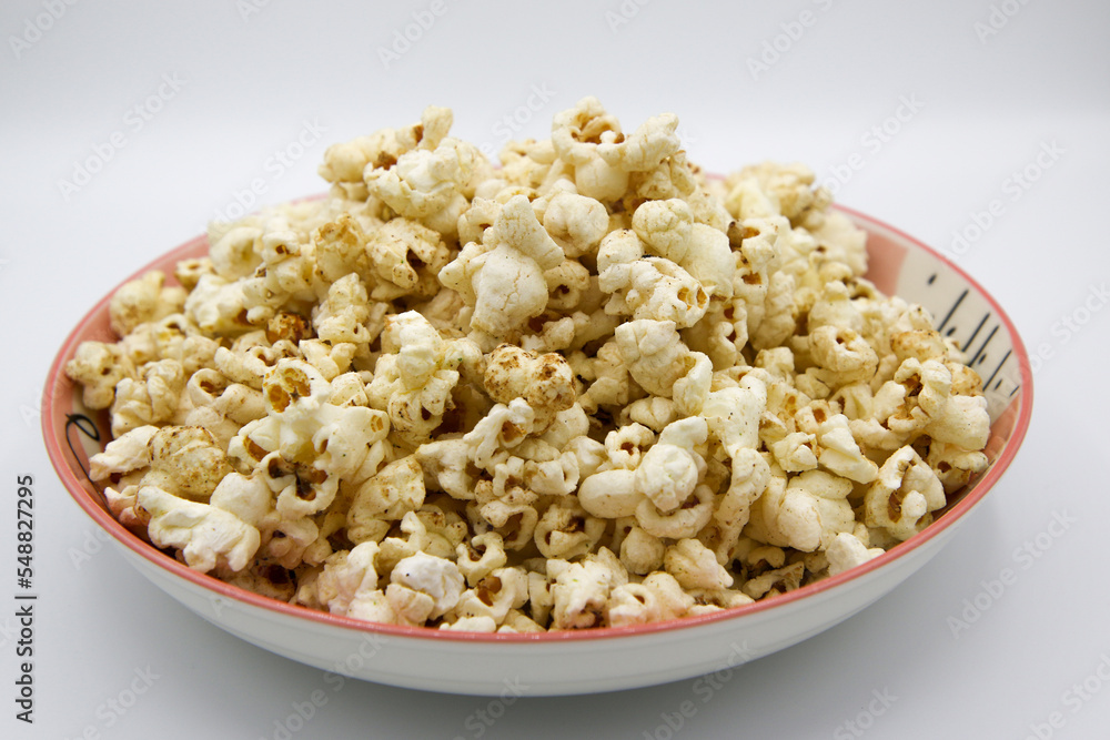 Popcorn on a plate on a white background Popcorn on a plate on a white background