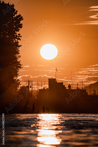 Sunset with people silhouetted playing on the beach