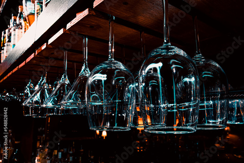 Wine & Martini stemware glasses hanging up behind bar