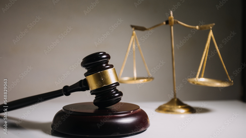 Business and lawyers discussing contract papers with brass scale on desk in office. Law, legal services, advice, justice and law concept Business and lawyers discussing contract papers with brass scale on desk in office. Law, legal services, advice, justice and law concept