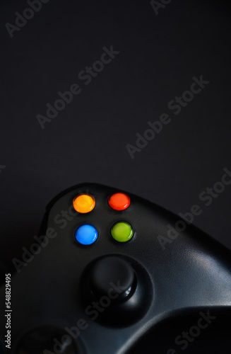 black joystick gamepad, game console on a black background. Video game management confrontation of a computer game competition. Cyberspace symbol