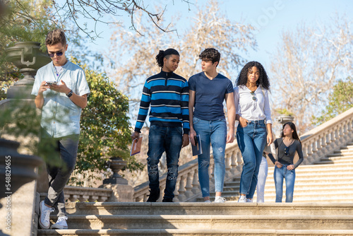 Group of young students walking on some stairs