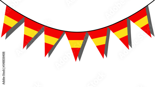 Banderines en forma de triangulo con la bandera de España colgados sobre una pared de fondo blanco haciendo sombra. Bandera de España. photo