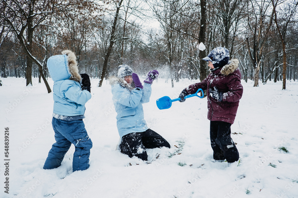 Happy Family, friends, mother and kids having fun outdoors in winter snowy nature background