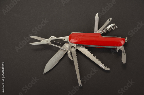 Open swiss army knife on a black background photo