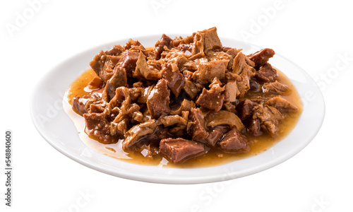 Wet cat food on a white plate cutout. Feeding plate full of meat and liver pieces in a sauce for cats isolated on a white background. Canned meat for domestic pet animals concept.