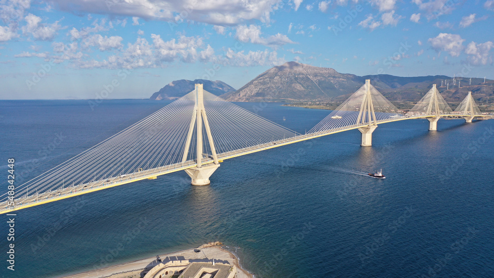 Aerial drone photo of famous state of the art modern cable strait bridge of Rio Antirio crossing corinthian gulf from Peloponnese seaside city of Rio to Antirio - mainland Greece