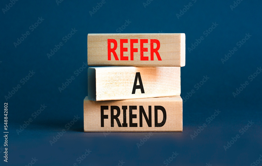 Refer a friend symbol. Concept words Refer a friend on wooden blocks on a beautiful grey table grey background. Business and refer a friend concept. Copy space. Refer a friend symbol. Concept words Refer a friend on wooden blocks on a beautiful grey table grey background. Business and refer a friend concept. Copy space.