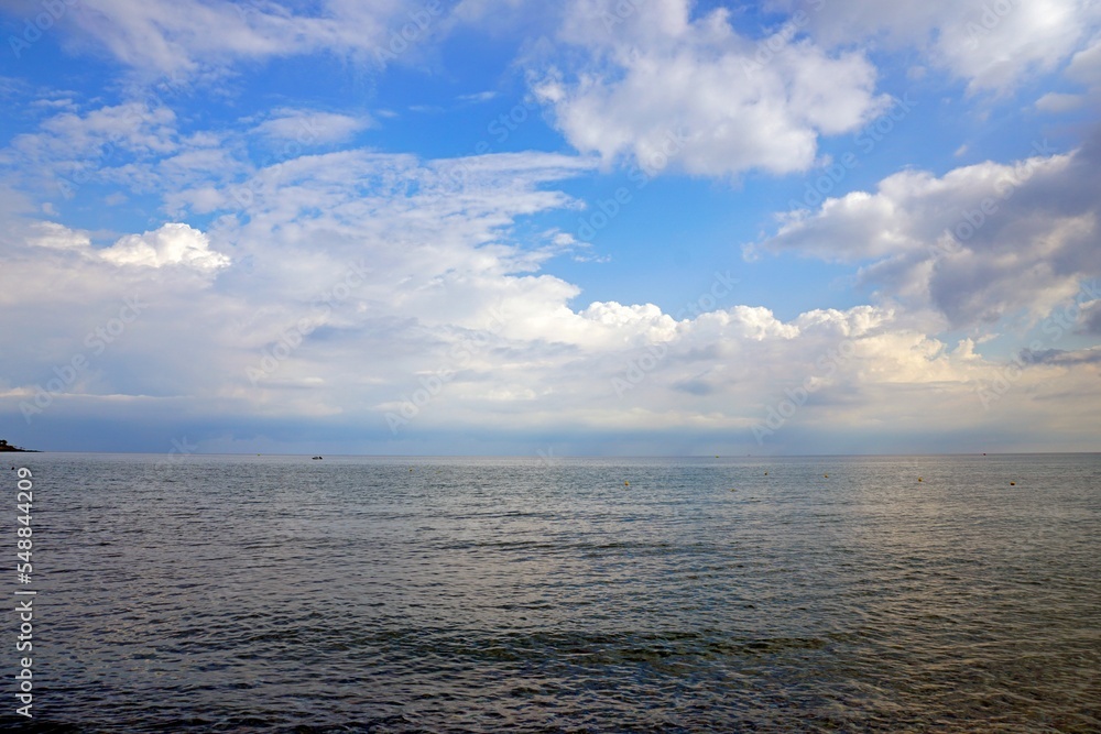 Fototapeta premium Aegean Sea in Crete. White clouds and blue sky. Sea distances and the horizon.