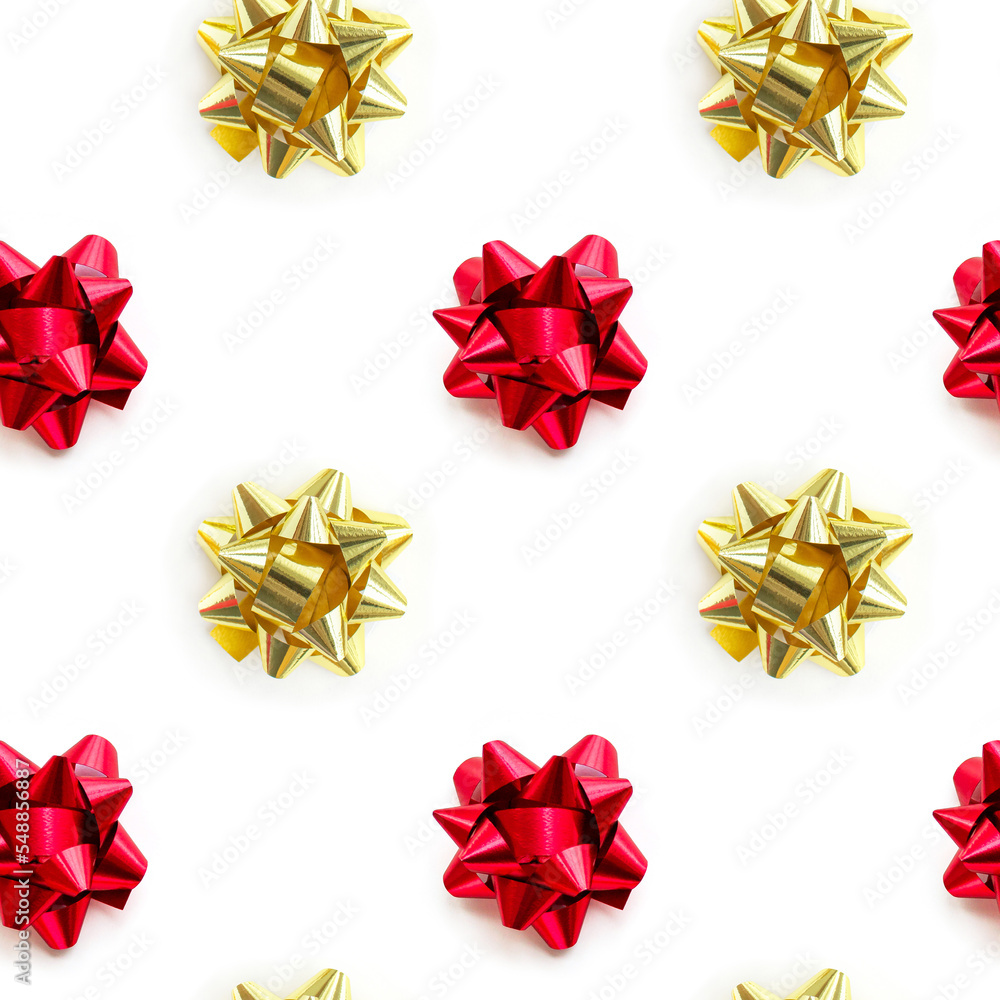 Christmas gold and red ribbon bow pattern on white background. Design composition for wrapping paper, birthday, christmas or greetings card. Christmas gold and red ribbon bow pattern on white background. Design composition for wrapping paper, birthday, christmas or greetings card.