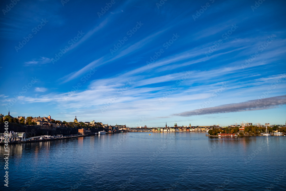 Aerial landscape of seacoast embankment city of Stockholm with buildings and houses in Baltic Sea with blue sky. Backdrop of amazing natural urban scenery view of Scandinavian nature. Copy text space