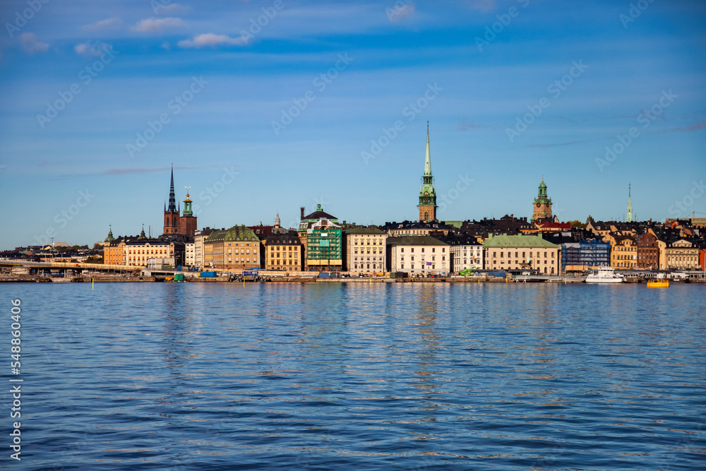 Scenic morning view of Gamla Stan in Old Town Stockholm, panorama embankment capital of Sweden with blue sky. Background of amazing urban scenery view of Scandinavian architecture. Copy text space
