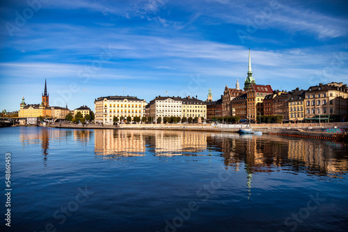 Scenic panoramic view of Gamla Stan in Old Town Stockholm, embankment capital of Sweden with blue sky. Background of amazing urban scenery view of Scandinavian swedish architecture. Copy text space © Alex Vog