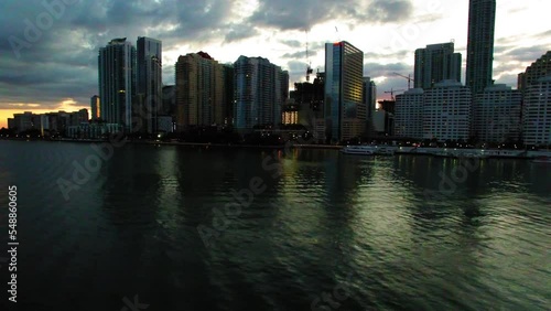 Wallpaper Mural Aerial Panning Shot Of Modern Office Towers Under Cloudy Sky, Drone Flying Over Ocean During Sunset - Miami, Florida Torontodigital.ca