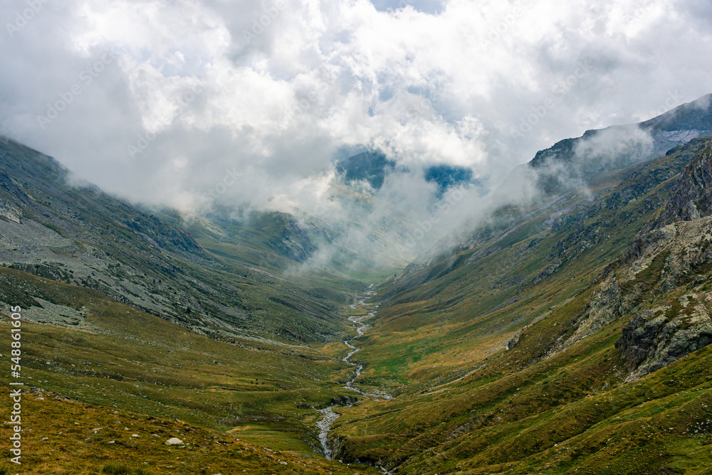 Fototapeta premium Mountain landscape with clouds on the valley and river