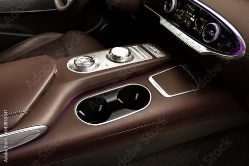 Cup holders inside modern car interior. Interior view of modern car. © Roman