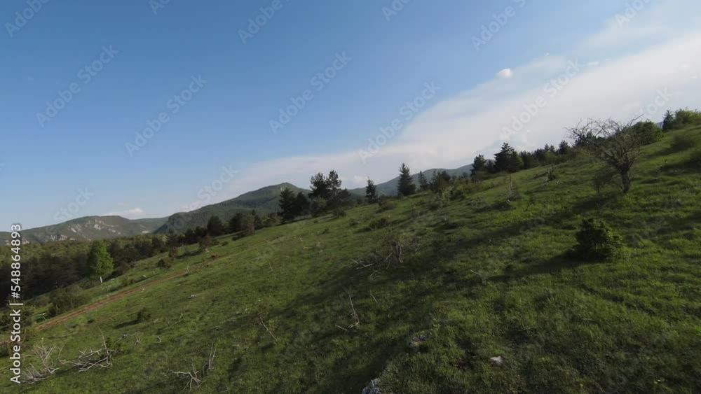 Fast and maneuverable flight over the hill with forest and tree tops with a beautiful sunset in the background. Filmed on FPV drone. Fast and maneuverable flight over the hill with forest and tree tops with a beautiful sunset in the background. Filmed on FPV drone.