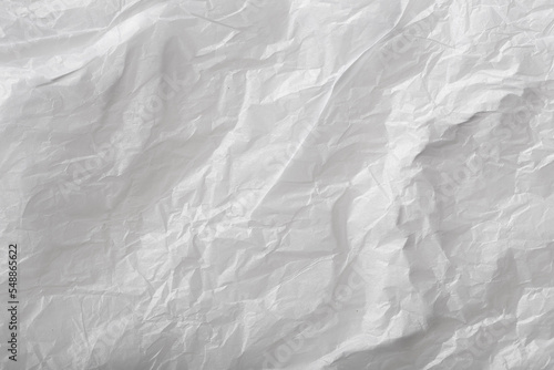 crumpled piece of paper against a harsh light white background