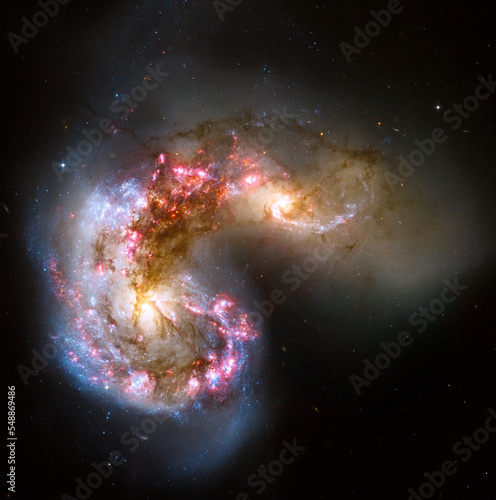 Antennae galaxies in a collision where billions of stars will be formed in space. Elements of this image furnished by NASA.