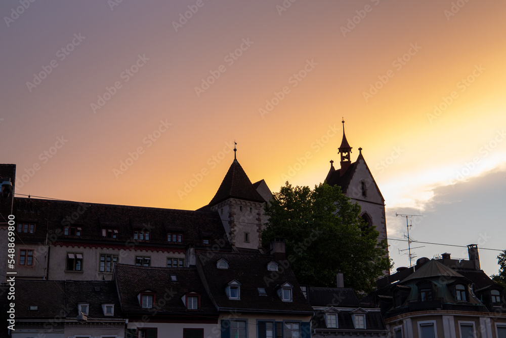 Sunset in a town in Switzerland with an orange light on its facades.