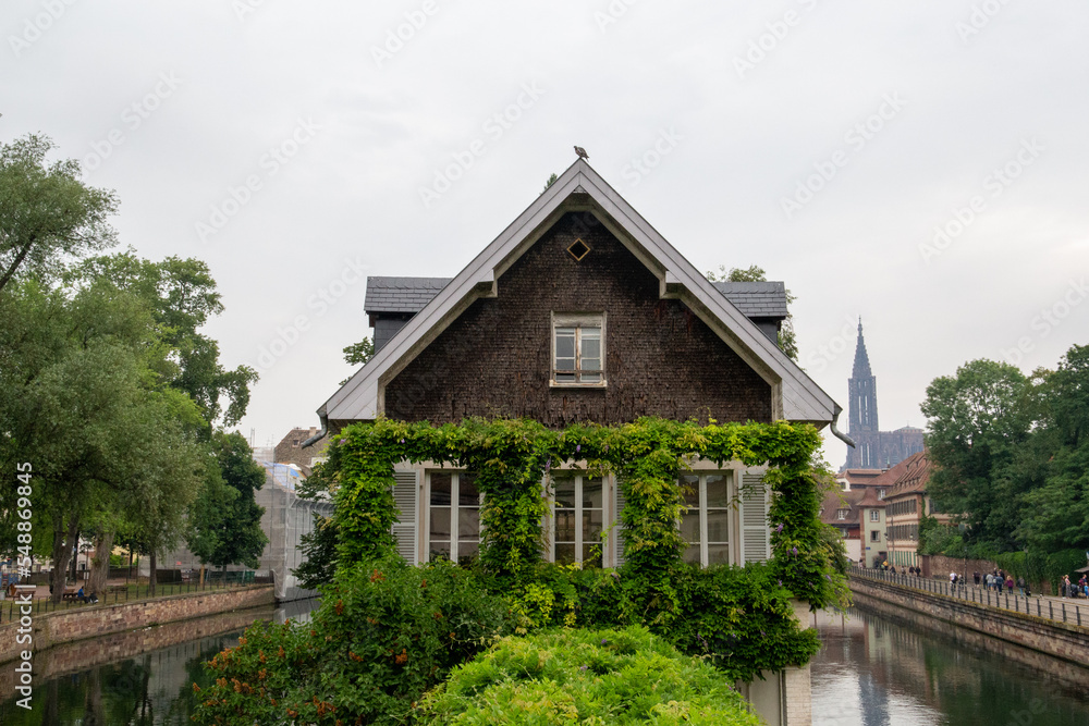 House surrounded by two canals and with a green area in front