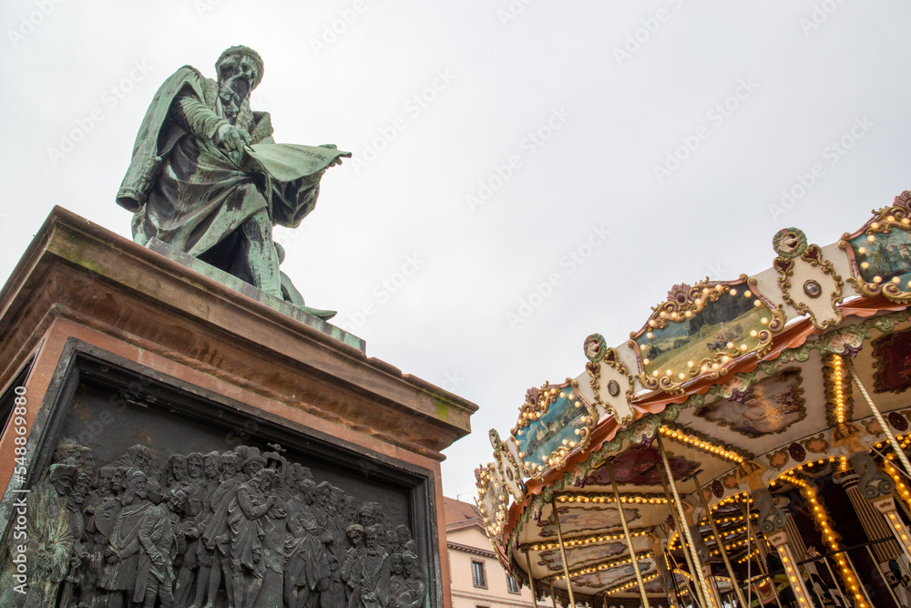 Statue next to a merry-go-round in a city in France