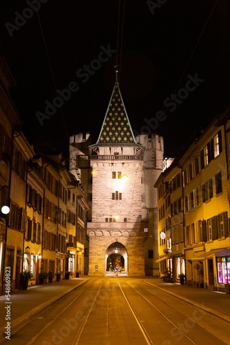 Old town in France at night illuminated by streetlights, with a castle