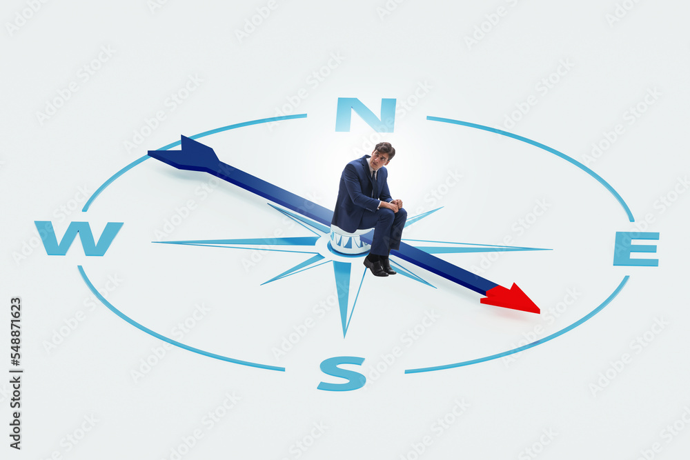 Businessman with compass looking for direction