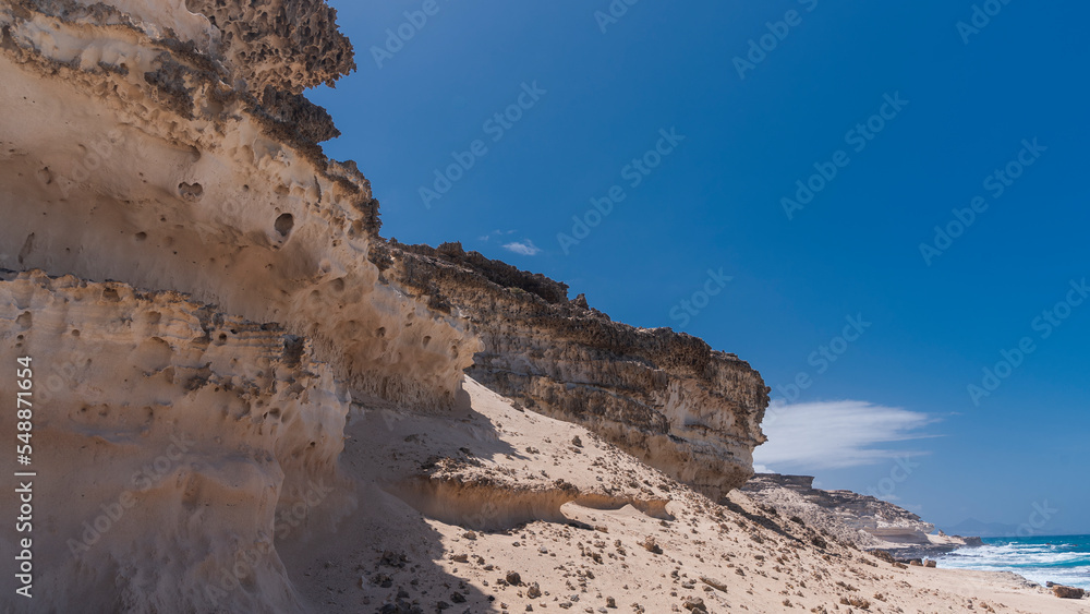 Coastal desert landscape made of  high, barren, hard rocky plateaus, West Coast, Fuerteventura, Spain