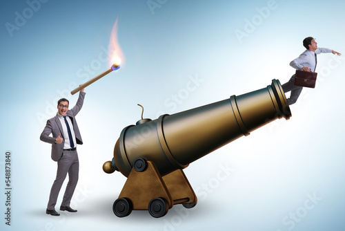 Konstfotografi Concept of lay-off with businessman and cannon