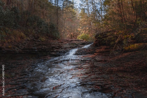 Cascades at bottom of a waterfall in the season of autumn