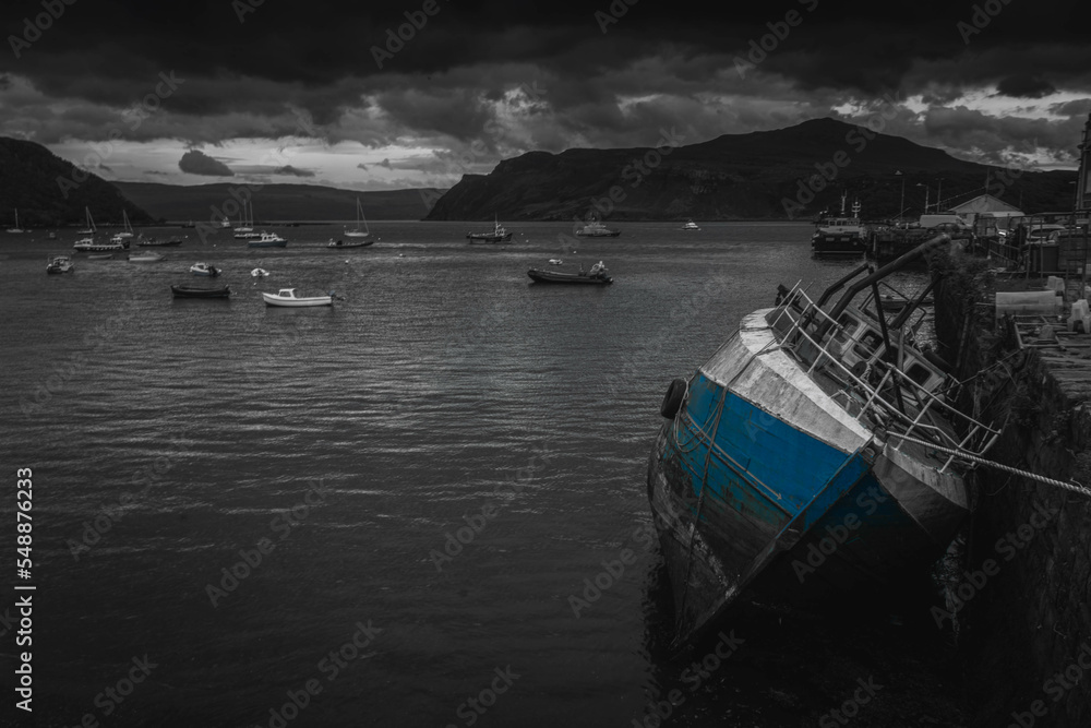 Fototapeta premium Blue boat laying down in a harbor