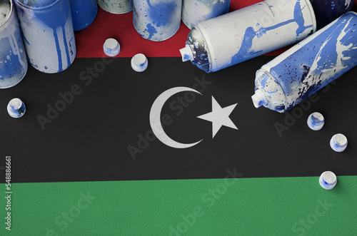 Libya flag and few used aerosol spray cans for graffiti painting. Street art culture concept