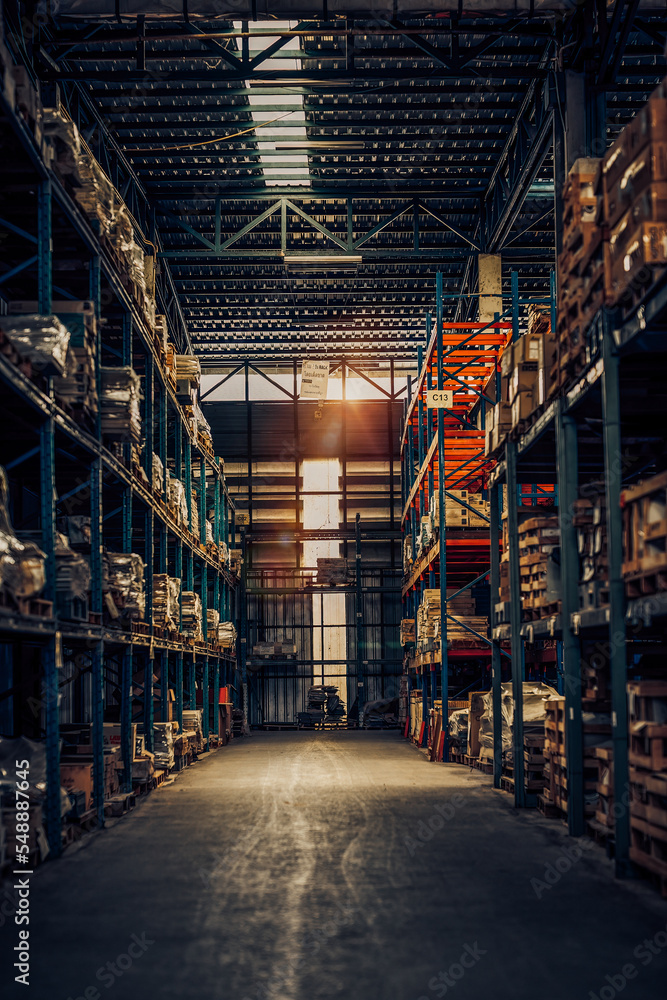 interior of modern retail warehouse storage with pallet trucks near shelves.Concept of warehouse forklifts between rows in a large warehouse. Dark Tone