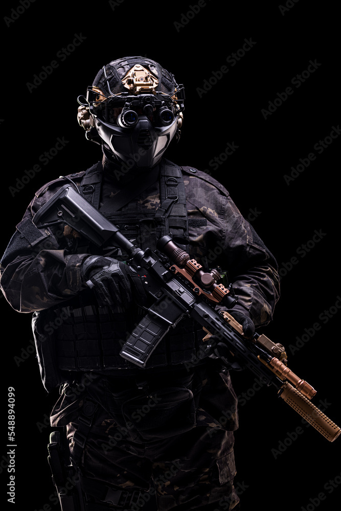 full body fully equipped soldier in tactical clothing and gear isolated on black background. full body fully equipped soldier in tactical clothing and gear isolated on black background.