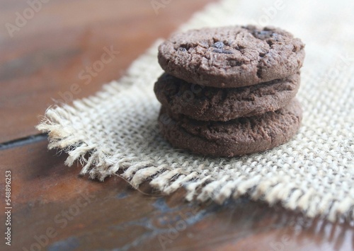 a pile of three chocolate cookies on the table
