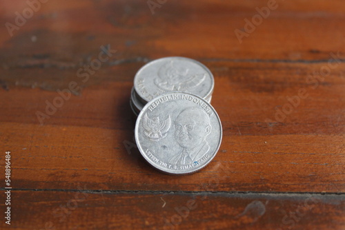 two silver rupiah coins on the table