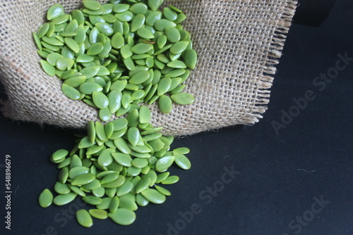 lamtoro seeds scattered on a black background photo