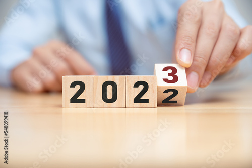 New project growth concept in 2023, Preparation for happy new year , Hand of man flip wooden cube from 2022 to 2023.