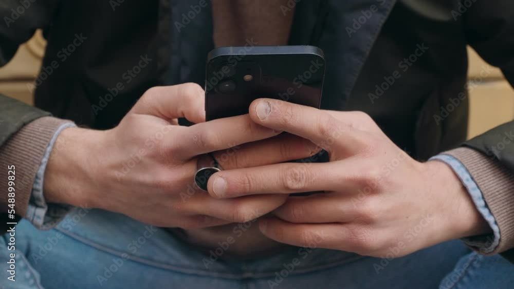globalization, connection - hands of young man typing on mobile phone keyboard globalization, connection - hands of young man typing on mobile phone keyboard