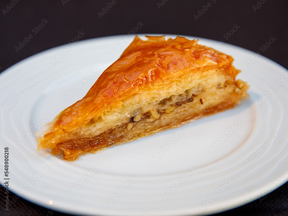 Piece of Carrot Slice Baklava (Turkish: Havuc Dilim Baklava) on white plate. Traditional Baklava from Gaziantep, Turkey. Baklava with walnut close up. Piece of Carrot Slice Baklava (Turkish: Havuc Dilim Baklava) on white plate. Traditional Baklava from Gaziantep, Turkey. Baklava with walnut close up.