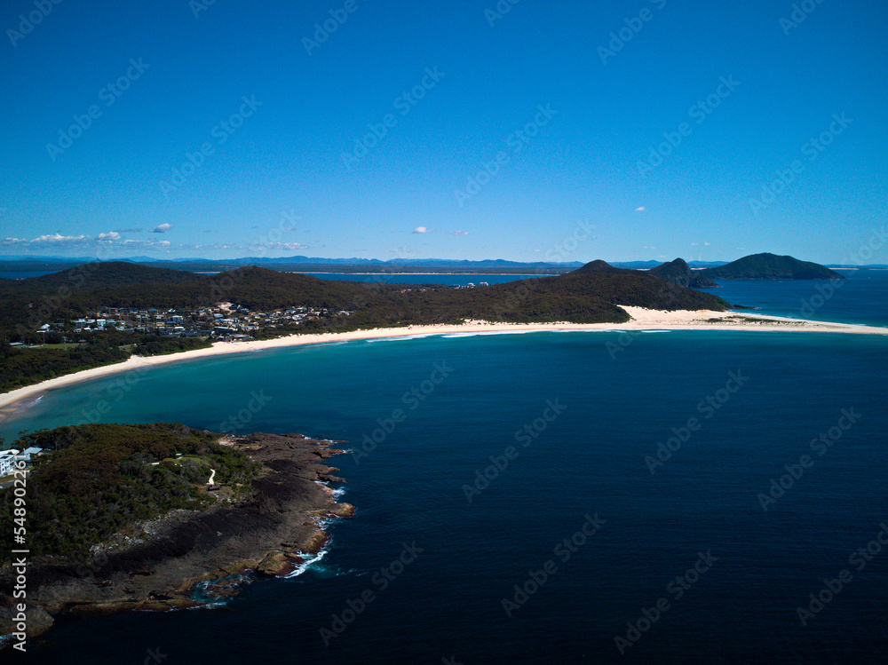 Drone photo of Fingal Bay and the spit leading to Shark Island on a bright sunny day Drone photo of Fingal Bay and the spit leading to Shark Island on a bright sunny day