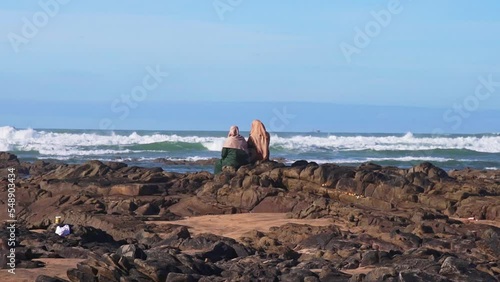 Women on the beach watching the ocean in Casablanca Morocco