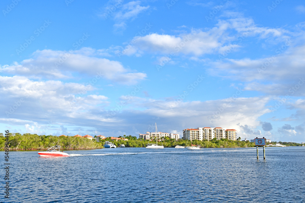 Boating along the intracoastal waterway with condos in the background in Jupiter, Florida