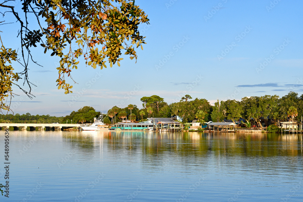Calm, quiet morning along the river with boats parked at docks in New Smyrna Beach, Florida