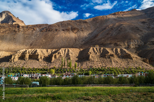 The landscape of the mountains. A scenic view of the green fields and ancient monastery in the Himalayan village of Tabo in the Spiti Valley in Himachal Pradesh, India. photo