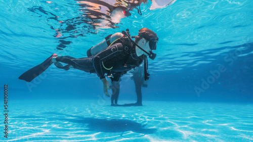 student doing scuba diving classes learning hover and buoyancy photo