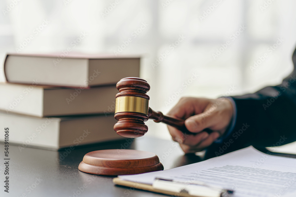 Lawyer office working with judge's hammer and gold scales Justice statue with scales and lawyer working on documents Advice and concept of justice Lawyer office working with judge's hammer and gold scales Justice statue with scales and lawyer working on documents Advice and concept of justice