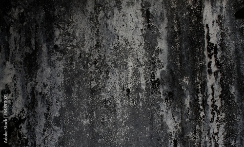 old cracked and worn wall background, vintage wall in industrial building with light from corner, cracked black concrete wall, gloomy cement texture background