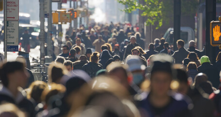 Anonymous crowd of people walking street